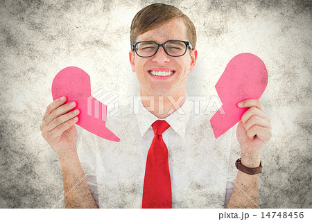 Composite image of geeky hipster holding a broken heart card 14748456