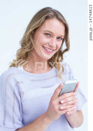 Smiling woman using smartphone 14748615