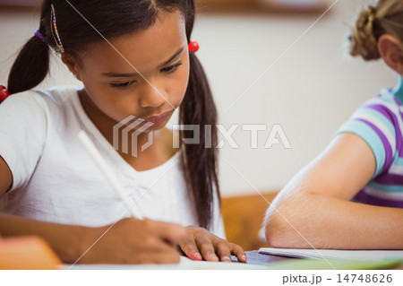 Schoolchildren working hard at desk 14748626