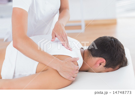 Physiotherapist doing back massage Physiotherapist doing back massage 14748773
