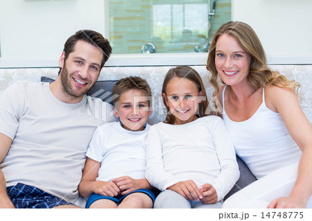 Happy family smiling at camera Happy family smiling at camera 14748775