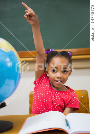 Pupil raising her hand during class 14748778