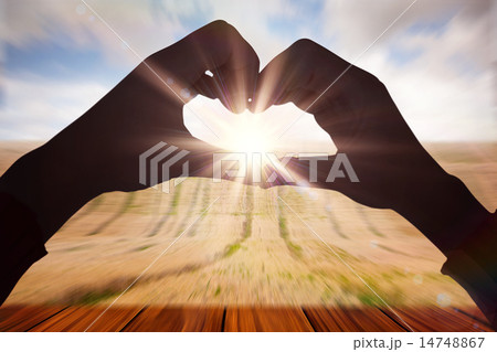 Composite image of woman making heart shape with hands 14748867