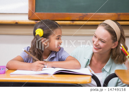 Teacher helping pupil in classroom Teacher helping pupil in classroom 14749158