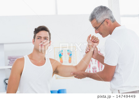 Doctor examining his patient arm 14749449