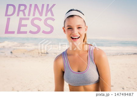 Composite image of sporty blonde on the beach smiling at camera Composite image of sporty blonde on the beach smiling at camera 14749487