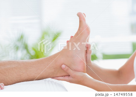 Physiotherapist doing foot massage Physiotherapist doing foot massage 14749558