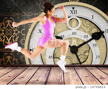 Composite image of fit brunette running and jumping 14749814
