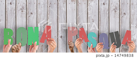 Composite image of hands holding up bona pasqua Composite image of hands holding up bona pasqua 14749838