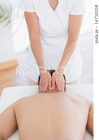 Physiotherapist doing neck massage to her patient Physiotherapist doing neck massage to her patient 14750208