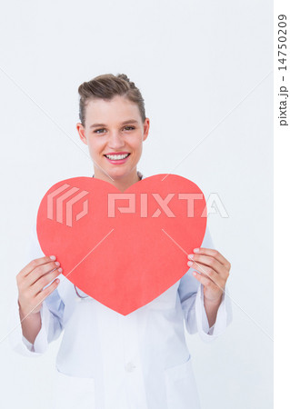 Smiling doctor holding heart card Smiling doctor holding heart card 14750209