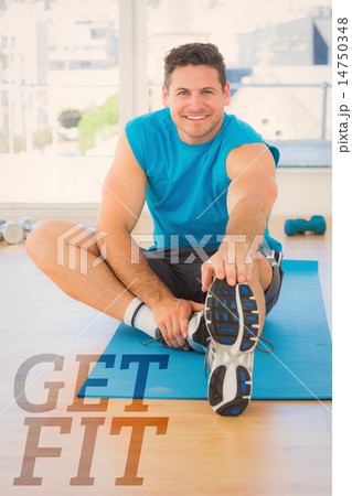 Composite image of sporty man stretching hand to leg in fitness Composite image of sporty man stretching hand to leg in fitness 14750348