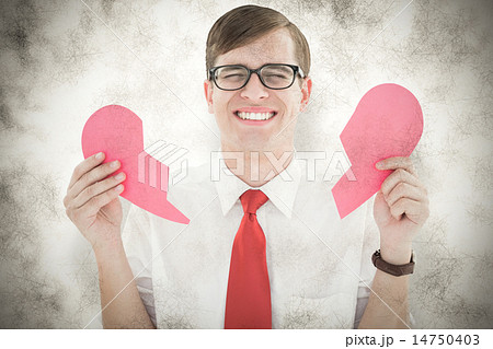 Composite image of geeky hipster holding a broken heart card 14750403