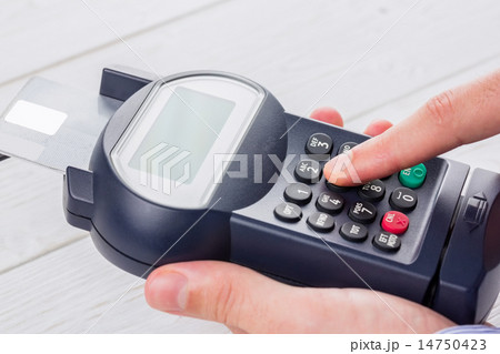 Man entering his pin on terminal 14750423