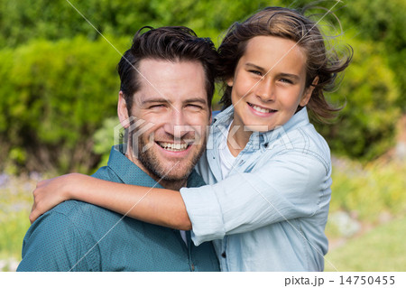 Father and son smiling at camera 14750455