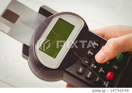 Man entering his pin on terminal 14750549