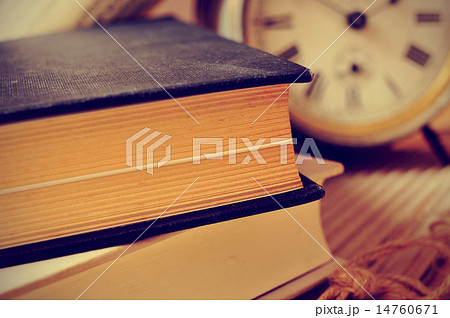 old books and an old alarm clock, with a retro effect 14760671
