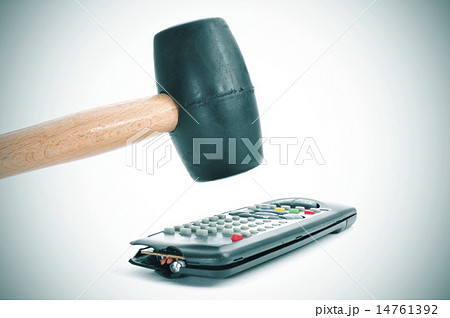 broking a remote control with a hammer 14761392
