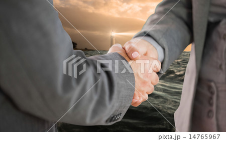 Composite image of business people shaking hands close up 14765967
