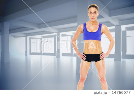 Composite image of strong blonde posing with hands on hips looki 14766077