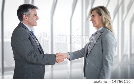 Composite image of pleased businessman shaking the hand of conte 14766110