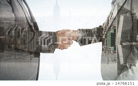 Composite image of close up on two businesspeople shaking hands 14766151