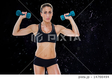 Composite image of female bodybuilder holding two dumbbells with Composite image of female bodybuilder holding two dumbbells with 14766494
