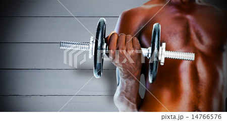Composite image of mid section of fit shirtless man holding dumb 14766576
