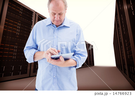 Composite image of mature man using his tablet pc 14766923