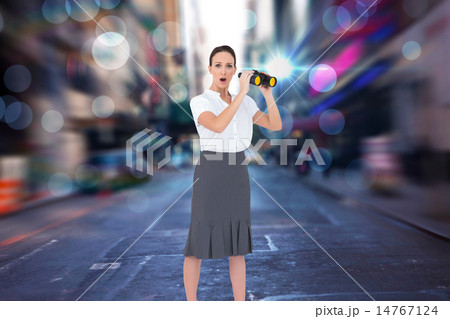 Composite image of astonished elegant businesswoman holding bino 14767124