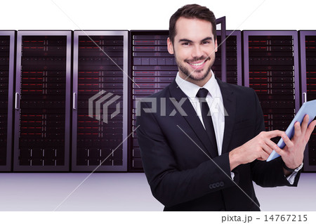 Composite image of businessman using his tablet while looking at Composite image of businessman using his tablet while looking at 14767215