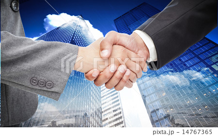 Composite image of handshake between two business people 14767365