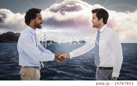 Composite image of smiling young businessmen shaking hands in of 14767853