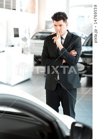 Handsome young man in dealership 14769559