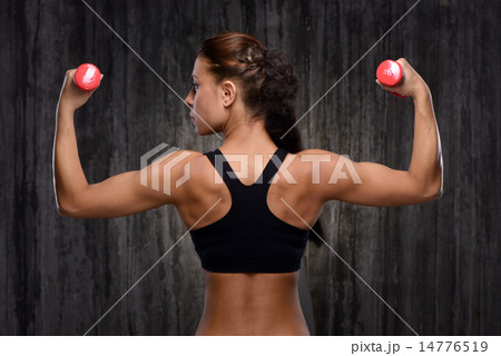 Back view of mixed race sporty woman with dumbbells 14776519