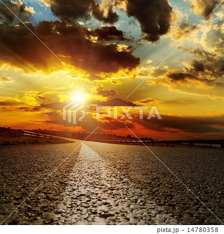 asphalt road and dramatic sunset over it 14780358