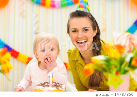 Portrait of mother with baby eating birthday cake Portrait of mother with baby eating birthday cake 14787850