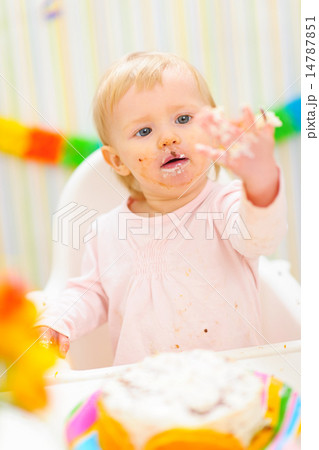 Portrait of baby smeared in birthday cake Portrait of baby smeared in birthday cake 14787851