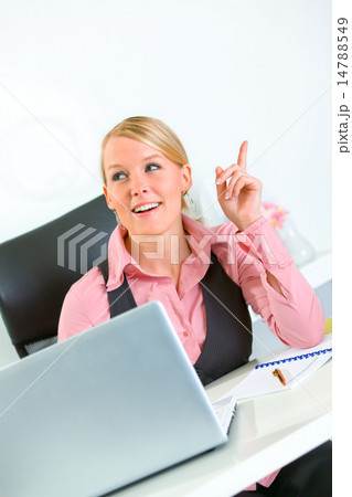 Pleased business woman got idea while sitting at office desk. Idea gesture. 14788549