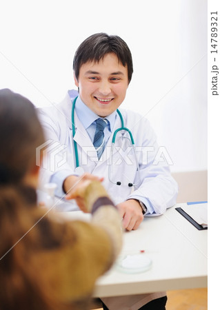Happy medical doctor and patient shaking hands 14789321