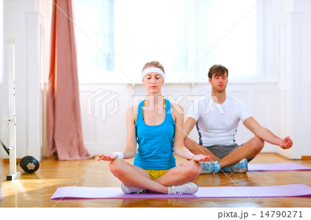 Young man and fit woman doing yoga at home 14790271