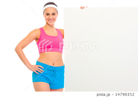 Smiling fitness young girl in sportswear holding blank billboard. Smiling fitness young girl in sportswear holding blank billboard. 14790352
