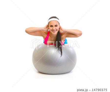 Smiling fit girl making exercise on fitness ball 14790375