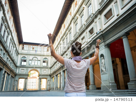 Young woman near uffizi gallery rejoicing in florence, italy. re 14790513