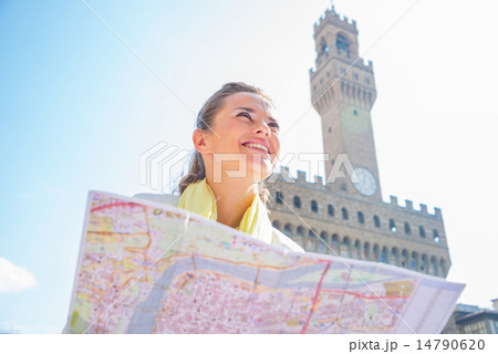 Happy young woman with map in front of palazzo vecchio in floren 14790620
