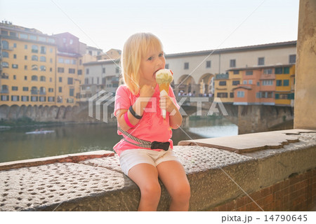 Portrait of happy baby girl eating ice cream near ponte vecchio Portrait of happy baby girl eating ice cream near ponte vecchio 14790645