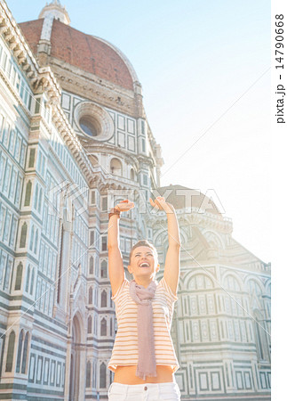 Portrait of happy young woman rejoicing in front of cattedrale d 14790668