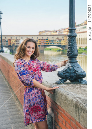 Happy young woman on embankment near ponte vecchio in florence, Happy young woman on embankment near ponte vecchio in florence, 14790822