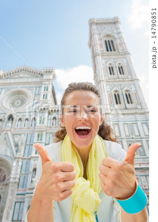 Happy young woman showing thumbs up in front of duomo in florenc Happy young woman showing thumbs up in front of duomo in florenc 14790851