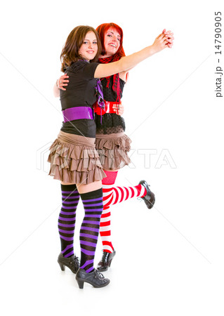 Two cheerful young girlfriends dancing for fun . Two cheerful young girlfriends dancing for fun . 14790905
